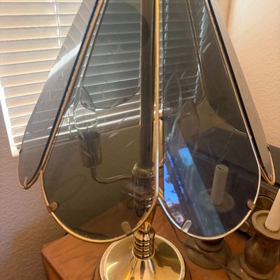Sale Photo Thumbnail #308: Vintage brass touch lamp featuring a metal base and a shade with smoked, etched glass panels, circa 1980s.