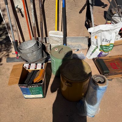 Sale Photo Thumbnail #58: Collection of outdoor garden tools, metal buckets, vintage fuel cans, and lawn care supplies including a bag of fertilizer.