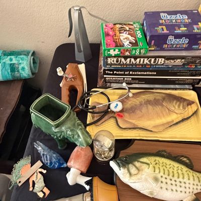 Sale Photo Thumbnail #108: Collection of tabletop novelties and games including a Big Mouth Billy Bass, a green elephant planter, board games, puzzles, and a stethoscope.
