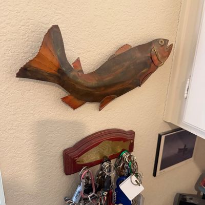Sale Photo Thumbnail #26: Handcrafted copper trout wall sculpture mounted above a fish-themed wooden key rack with attached keychains.