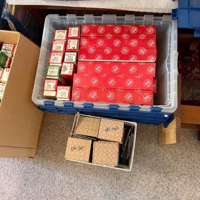 Sale Photo Thumbnail #162: Collection of vintage QRS player piano rolls stored in plastic totes and cardboard boxes.