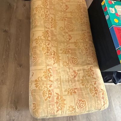 Sale Photo Thumbnail #104: Rectangular upholstered seat cushion featuring a yellow and orange floral patterned fabric.
