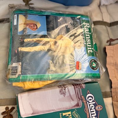 Sale Photo Thumbnail #169: Vintage Academy Broadway yellow rainsuit in original plastic packaging alongside a boxed Coleman stainless steel flask.