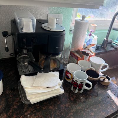 Sale Photo Thumbnail #22: Black Krups combination espresso and drip coffee maker displayed on a kitchen countertop alongside various coffee mugs.