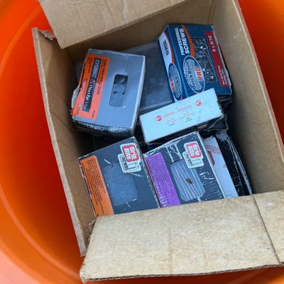 Sale Photo Thumbnail #221: Cardboard box filled with assorted hardware including Grip Rite fasteners, Everbilt drywall screws, and Quick Build Pro professional screws.