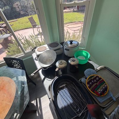 Sale Photo Thumbnail #85: Selection of kitchen cookware and appliances, including a double burner hot plate, electric rice cooker, speckled enamel roaster, colander, and pot holders.
