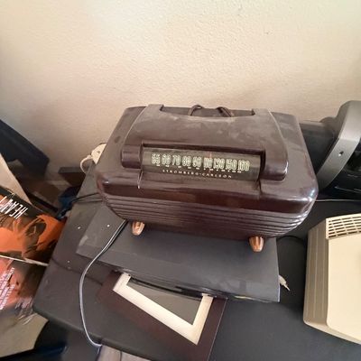 Sale Photo Thumbnail #98: Vintage Stromberg-Carlson brown Bakelite tabletop radio with ribbed casing and analog frequency display.