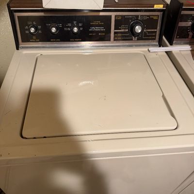 Sale Photo Thumbnail #73: Vintage Lady Kenmore top-loading washing machine in almond finish with faux woodgrain control panel trim, circa 1980s.