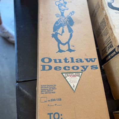 Sale Photo Thumbnail #245: Vintage Outlaw Decoys cardboard box from Spokane, Washington, featuring printed logo graphics and company details.