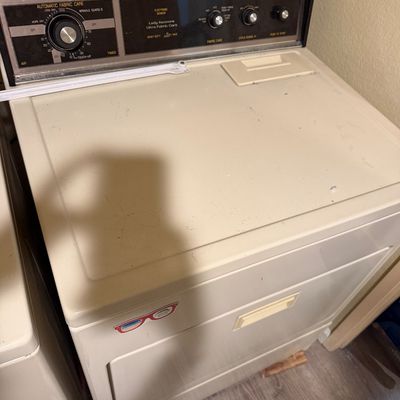 Sale Photo Thumbnail #74: Vintage Lady Kenmore Ultra Fabric Care electric clothes dryer featuring a faux-woodgrain top panel and cream-colored cabinet.