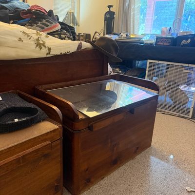 Sale Photo Thumbnail #293: Pair of vintage wooden bedside nightstands featuring glass insert tops and integrated handles.