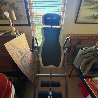 Sale Photo Thumbnail #141: Elite Fitness inversion table featuring a padded backrest and headrest on a sturdy tubular metal frame.