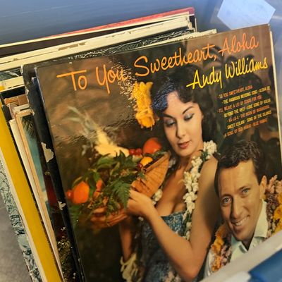 Sale Photo Thumbnail #29: A plastic storage bin filled with vintage vinyl LP records, featuring Andy Williams' album "To You Sweetheart, Aloha" on top.
