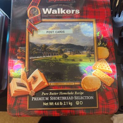 Sale Photo Thumbnail #320: Vintage Kirkland Signature Walkers shortbread cookie tin with a red plaid pattern and framed landscape illustration, repurposed with a label reading "POST CARDS".