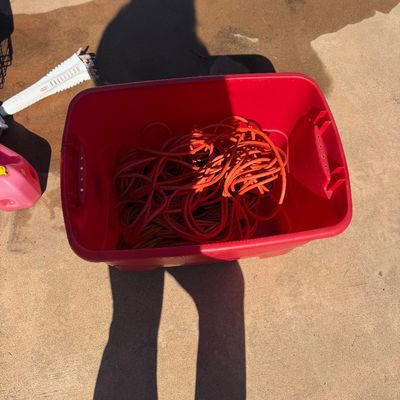 Sale Photo Thumbnail #56: Red plastic storage tote filled with a heavy-duty orange extension cord.