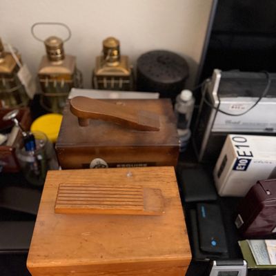 Sale Photo Thumbnail #196: Two vintage wooden shoe shine valet boxes with integrated footrests, displayed among electronics and brass lanterns.