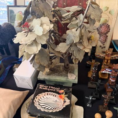 Sale Photo Thumbnail #160: Vintage Chinese carved stone bonsai glass flower tree in a jade planter, surrounded by assorted home decor items including small totem poles and boxed silverplate trays.