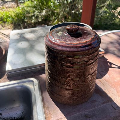 Sale Photo Thumbnail #69: Vintage dark brown glazed ceramic canister with matching lid featuring raised embossed lettering and textured band details.