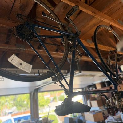 Sale Photo Thumbnail #48: Vintage blue road bicycle suspended upside down from garage rafters, showing signs of dust and age.