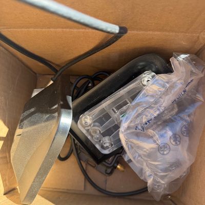 Sale Photo Thumbnail #273: Assorted electronics parts and accessories, including wiring and hardware, packed inside a cardboard box.