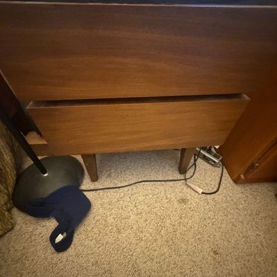 Sale Photo Thumbnail #304: Mid-century modern two-drawer wooden nightstand or small chest featuring tapered legs and handleless drawer fronts.