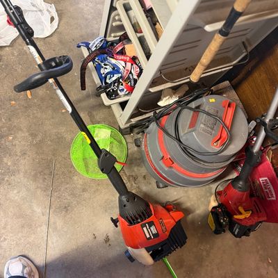 Sale Photo Thumbnail #208: Collection of garage items featuring gas-powered weed trimmers, a wet/dry shop vacuum, fishing rod, and plastic storage cart.