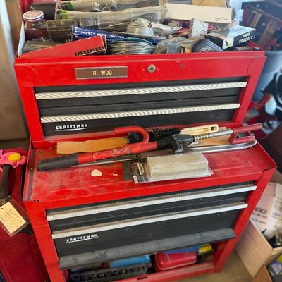 Sale Photo Thumbnail #246: Red Craftsman two-piece rolling tool chest combo, filled with various hand tools, hardware, and accessories.
