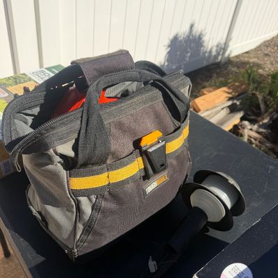 Sale Photo Thumbnail #279: ToughBuilt heavy-duty tool tote bag alongside a landscape solar light stem outdoors.