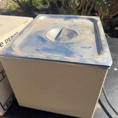 Sale Photo Thumbnail #275: Vintage beige metal card file box featuring a stainless steel lid with an integrated handle, showing minor surface wear and dust.