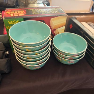 Sale Photo Thumbnail #28: Set of turquoise floral patterned bowls stacked alongside a boxed sushi maker.