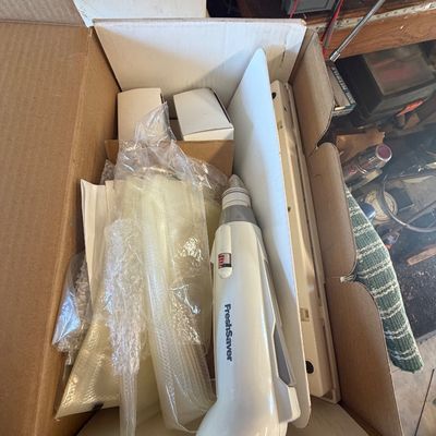 Sale Photo Thumbnail #231: Box containing a handheld FoodSaver FreshSaver vacuum sealer along with sealed bags and accessories.