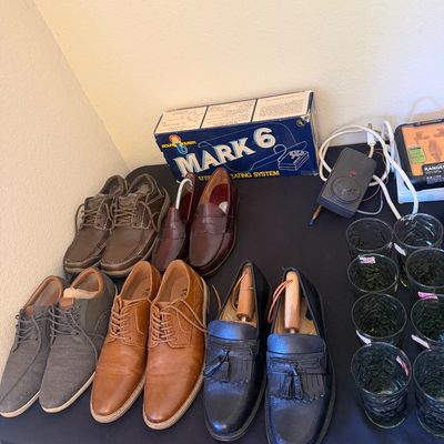 Sale Photo Thumbnail #324: Collection of men's dress shoes and loafers, alongside boxed vintage Mark 6 heating system and green textured glassware.