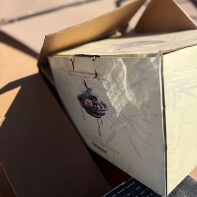 Sale Photo Thumbnail #259: Open cardboard box containing a Relaxor brand tabletop fountain sculpture in its original packaging.