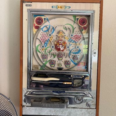 Sale Photo Thumbnail #295: Vintage Nishijin Japanese pachinko machine mounted in a wooden frame cabinet, circa 1970s.