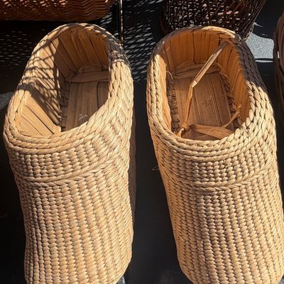 Sale Photo Thumbnail #285: Pair of vintage woven straw or reed clog-style shoes or decorative planters featuring intricate coiled weave construction.
