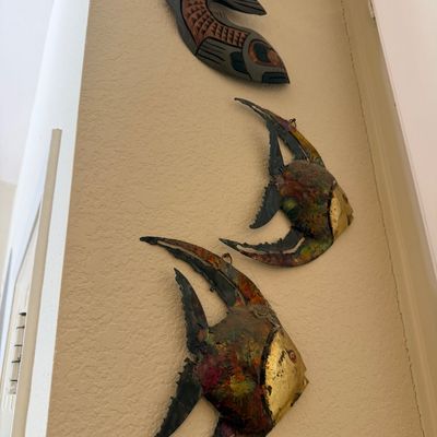 Sale Photo Thumbnail #27: Set of three vintage fish wall sculptures, including two painted metal angelfish and one carved wooden fish mask.