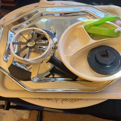 Sale Photo Thumbnail #312: Selection of kitchen gadgets, including an apple slicer and divided tray accessories, displayed on a silver-tone serving tray.