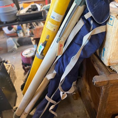Sale Photo Thumbnail #46: Collection of outdoor surveying and field equipment, including transit tripods in carrying cases and a yellow protective case.