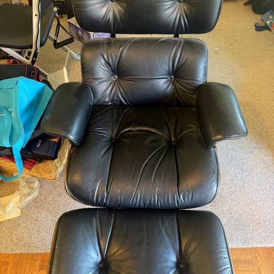 Sale Photo Thumbnail #325: Eames-style lounge chair and matching ottoman in black tufted leather with bentwood shells.