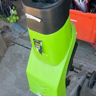Sale Photo Thumbnail #222: Portland electric wood chipper and shredder in bright green and black plastic housing, showing minor wear and peeling labels.