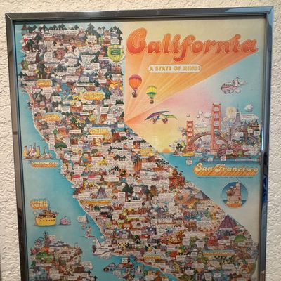 Sale Photo Thumbnail #110: Vintage framed vintage Hallmark pictorial map poster titled "California A State of Mind!", featuring colorful cartoon illustrations of state landmarks in a chrome frame.