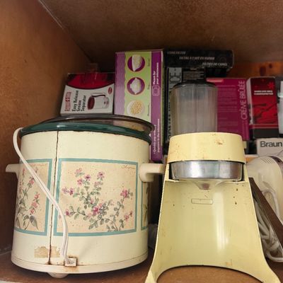 Sale Photo Thumbnail #15: Vintage Rival Crock-Pot slow cooker with a floral herb motif alongside a vintage cream-colored electric citrus juicer.