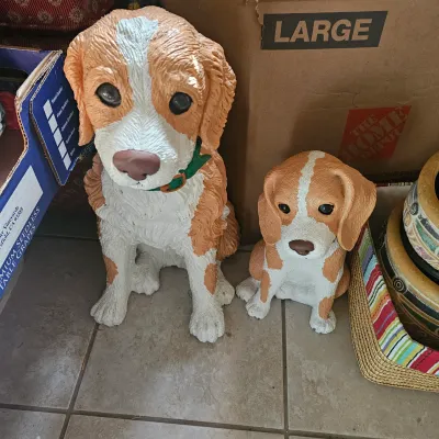 Sale Photo Thumbnail #5: Pair of painted resin or ceramic dog statues, including a larger spaniel figure and a smaller beagle-style puppy statue.