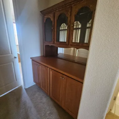 Sale Photo Thumbnail #73: Traditional oak hutch and buffet cabinet featuring glass-front upper doors with leaded detail and a mirrored back splash.