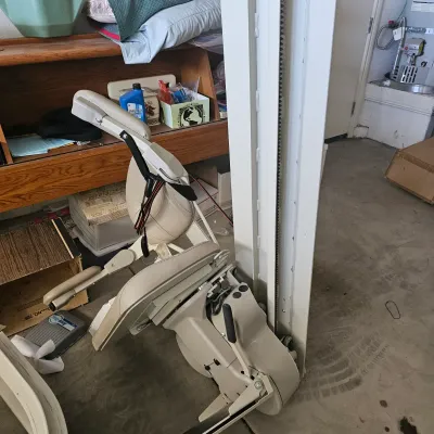 Sale Photo Thumbnail #54: Motorized stair lift chair mechanism with beige padded seat and track assembly, 