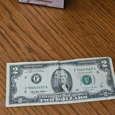 Sale Photo Thumbnail #86: Series 1995 United States two-dollar bill featuring Thomas Jefferson, showing a center crease.