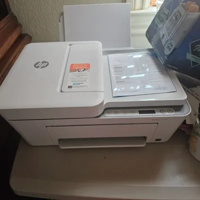 Sale Photo Thumbnail #34: HP DeskJet all-in-one printer in white, complete with original documentation on the scanner glass.