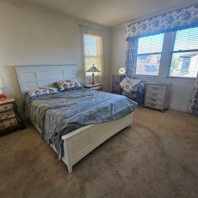 Sale Photo Thumbnail #66: White panel-style queen bed frame paired with matching French provincial-style nightstands and a three-drawer chest.