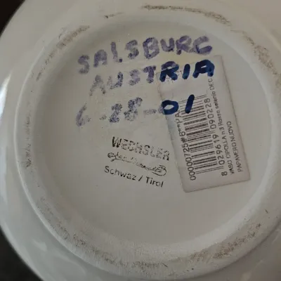 Sale Photo Thumbnail #33: Bottom stamp mark reading "WECHSLER Schwaz / Tirol" alongside hand-written text and barcode sticker on a white ceramic item.