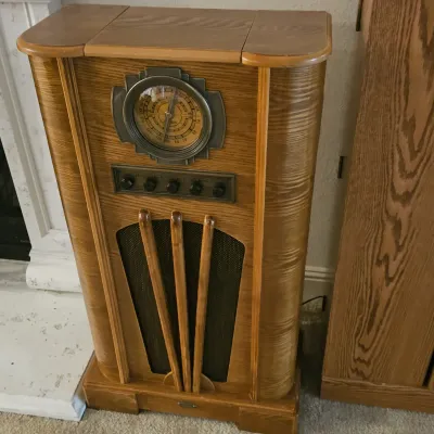 Sale Photo Thumbnail #89: Art Deco style oak floor-standing floor console radio with rounded sides and a large round tuning dial.